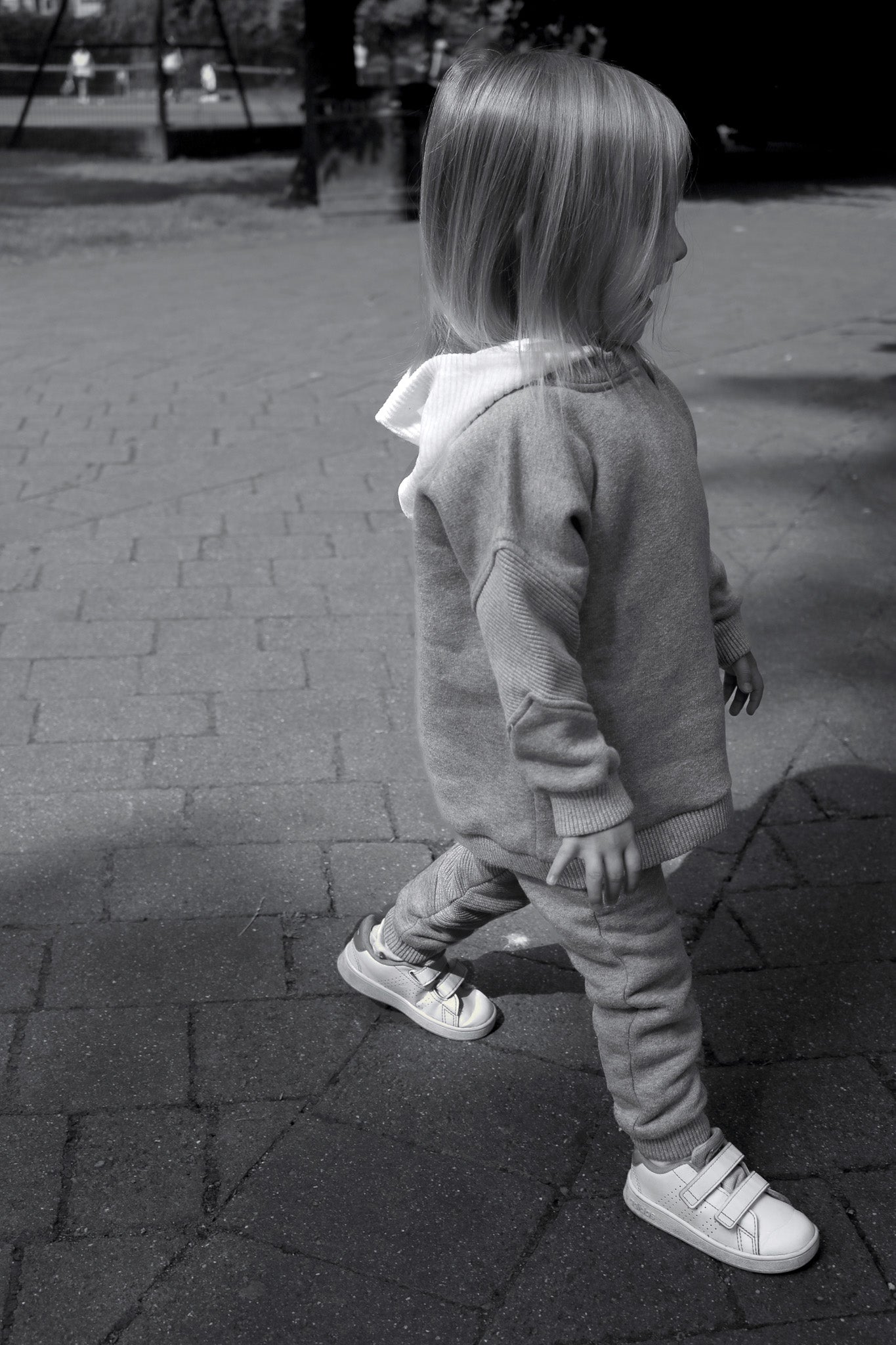 Editorial image of child wearing cosy hooded sweatshirt paired cosy jogger in melange grey