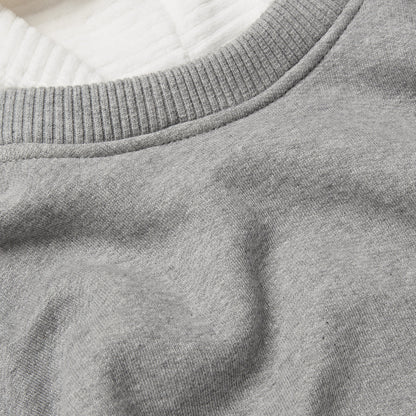 Close up detail of grey melange fabric plus ribbed neckline